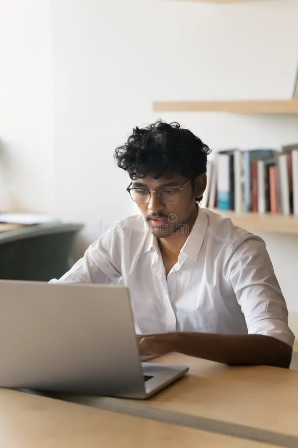 focused busy young indian business professional man working laptop office sitting table typing serious smart male student 367578654